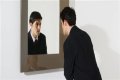 Why do I look uglier in pictures than in the mirror?